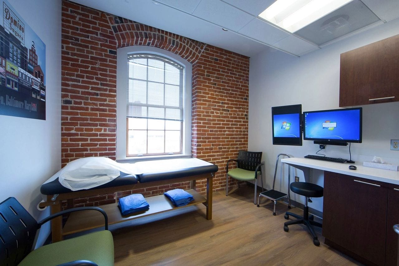 room with patient bed and two computer monitors