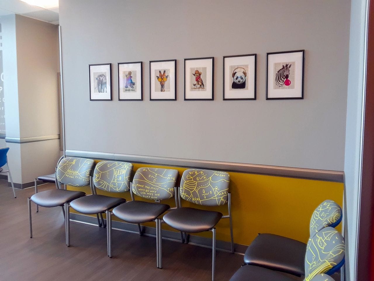 set of chairs and a wall with animal pictures