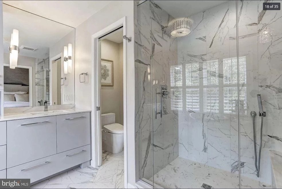 bathroom with white marble design and shower enclosure