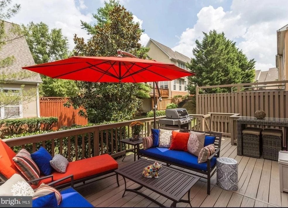 wooden deck with chairs and umbrella
