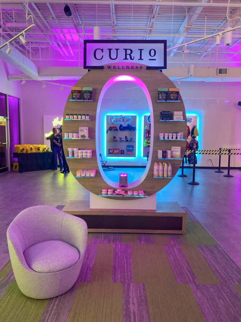 Letter O shaped kiosk by Curio and a comfy chair